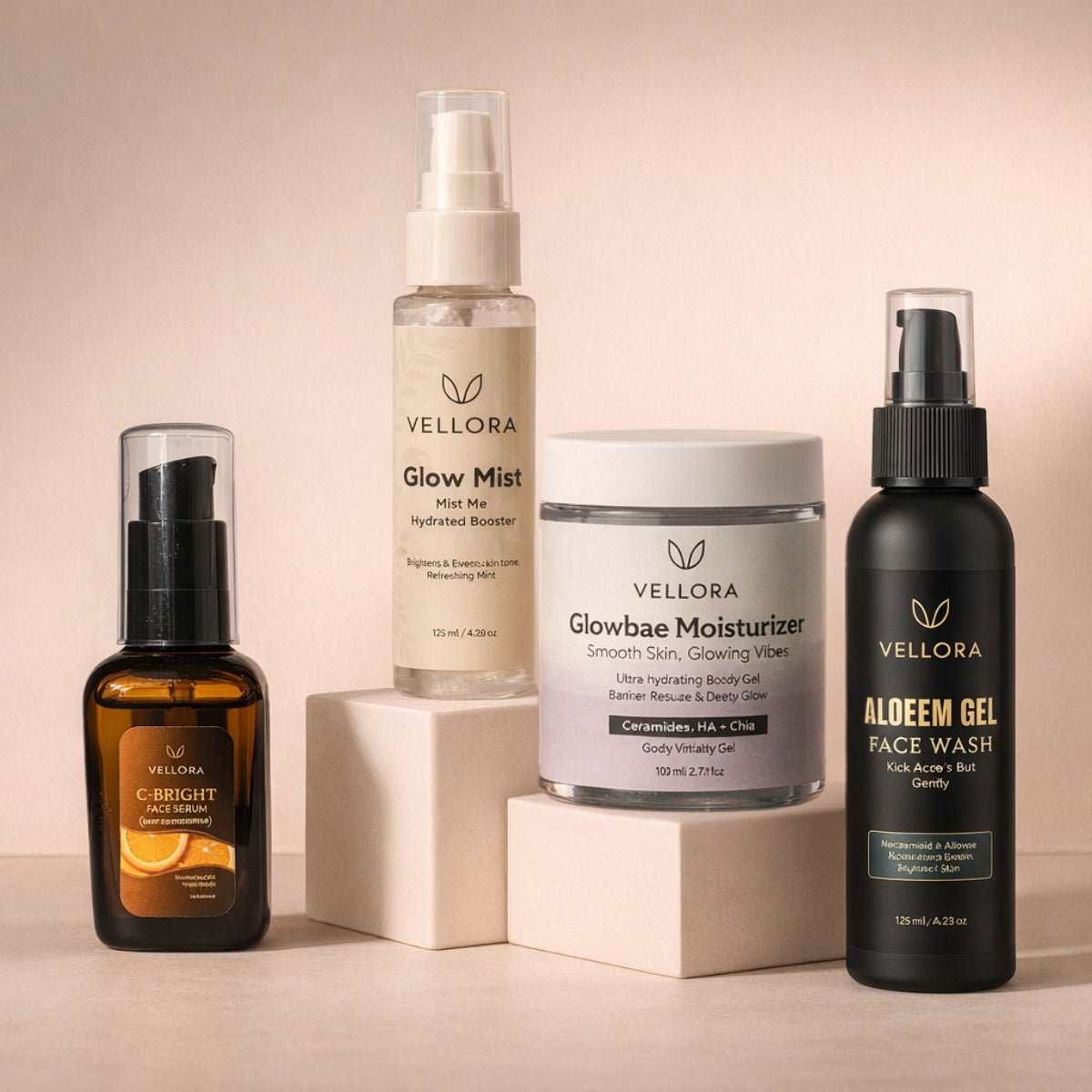 Vellora Complete Glow Routine for acne-prone skin featuring C-Bright Face Serum, Glow Mist, Glowbae Moisturizer, and Aloeem Gel Face Wash displayed on minimal studio blocks