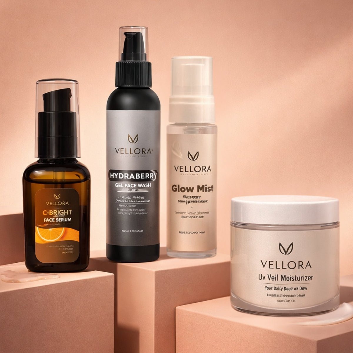 Vellora Complete Glow Routine for dry and sensitive skin featuring C-Bright Face Serum, Hydraberry Gel Face Wash, Glow Mist, and UV Veil Moisturizer arranged in a minimal studio setting