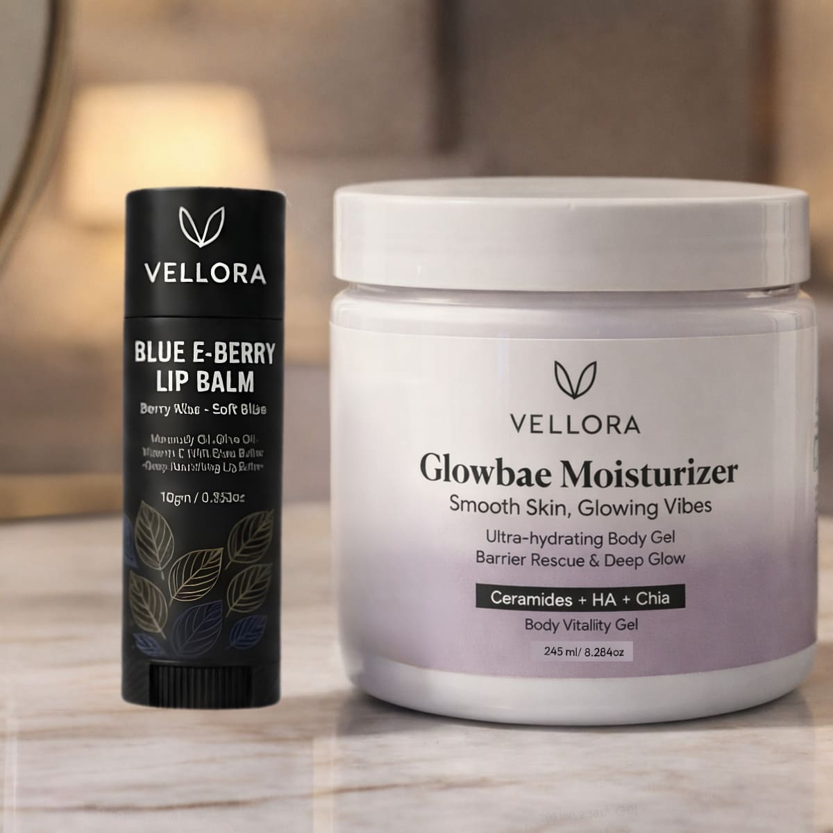 VELLORA Glowbae Moisturizer jar with ceramides, hyaluronic acid and chia placed beside VELLORA Blue E-Berry Lip Balm, showcasing a hydrating skincare and lip care combo for smooth, nourished skin and soft lips.