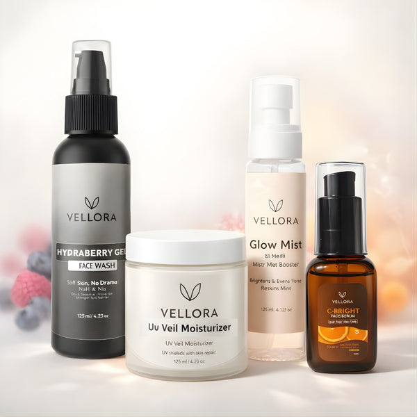 Vellora Complete Glow Routine for dry and sensitive skin featuring C-Bright Face Serum, Hydraberry Gel Face Wash, Glow Mist, and UV Veil Moisturizer arranged in a minimal studio setting