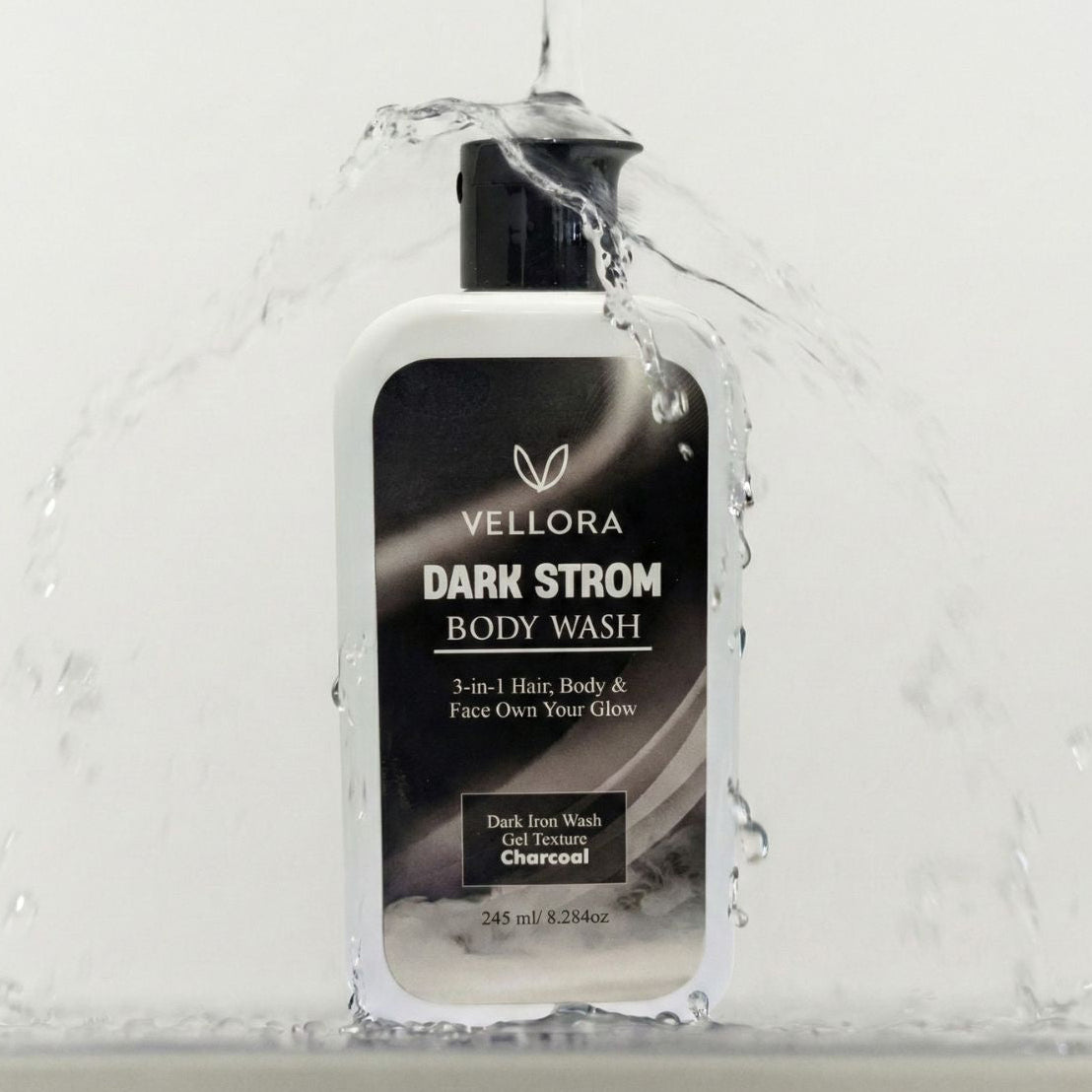 Vellora Dark Strom Body Wash in hand under running water, 3-in-1 charcoal gel cleanser for face, body and hair, deep cleansing body wash for sweat, odor and oil control in Indian climate.