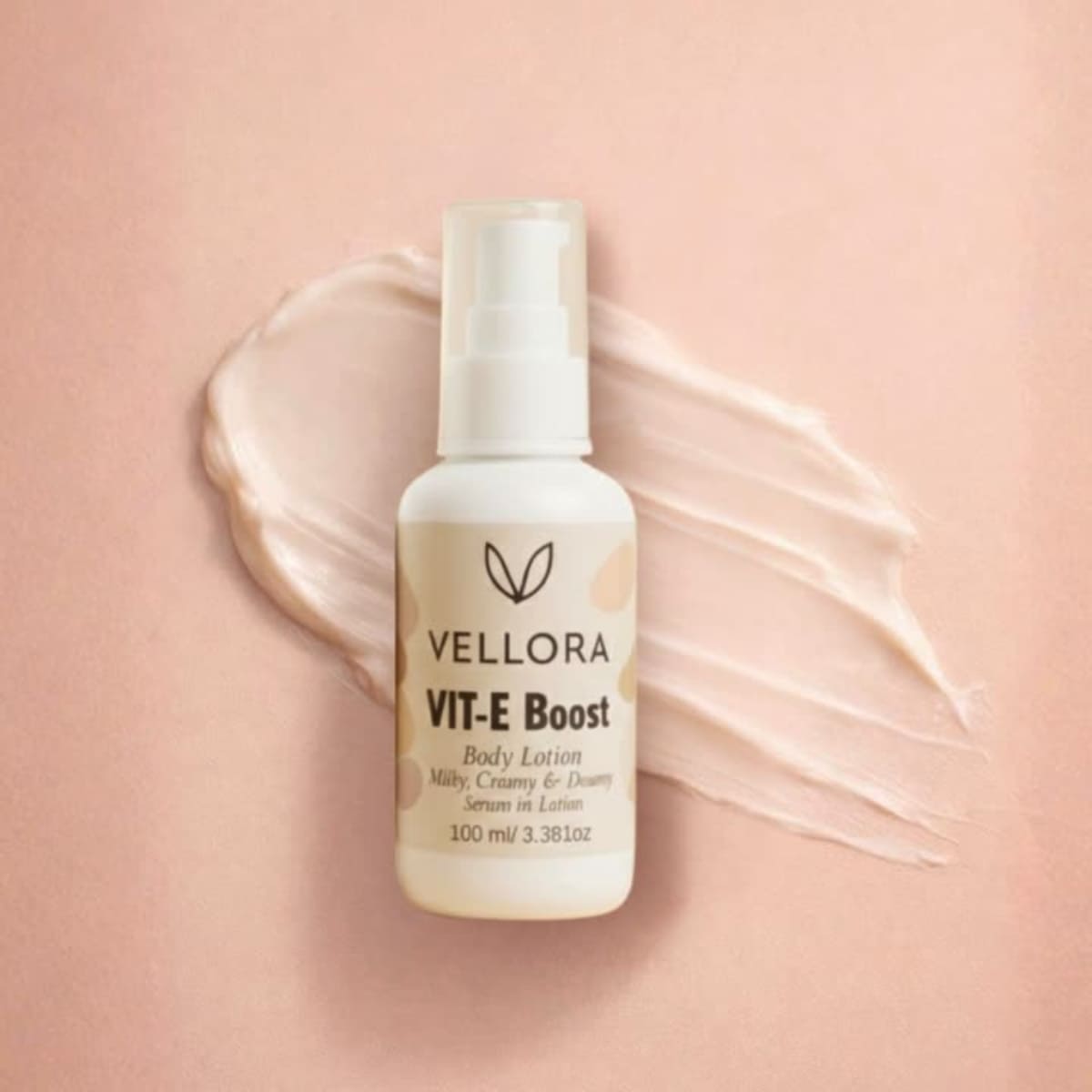 Vellora VIT-E Boost Body Lotion 100 ml with creamy texture smear, vitamin E enriched serum-in-lotion for deep hydration, nourishment and soft glowing skin for daily body care.